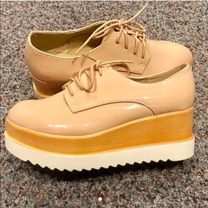 Patient pink Oxford platform shoes in size 9